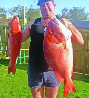 Llew shows off a 14kg large mouth sea perch and a prized 3kg coral trout brought to his boat from Cape Capricorn.